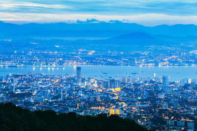 Aerial view of illuminated cityscape against sky