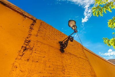 Low angle view of street light against building