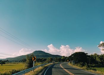 Road passing through landscape against sky