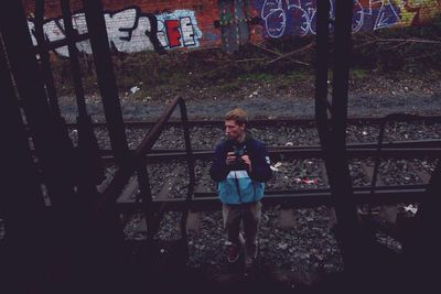 Full length of girl standing against railing