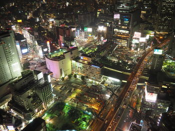 High angle view of city lit up at night