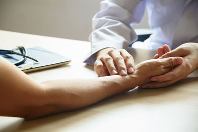 Close-up of people on table