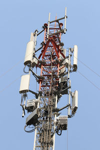 Low angle view of communications tower against sky