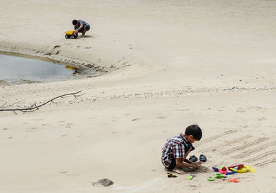 High angle view of people sitting on beach