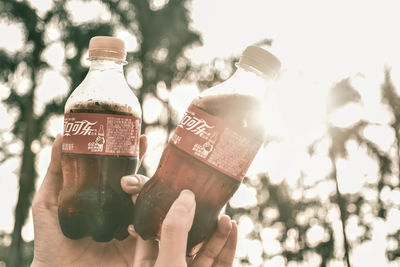 Close-up of hand holding glass bottle