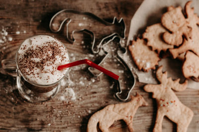 Diy christmas cookies. hot chocolate with cream and biscuits. animal figurine cookies