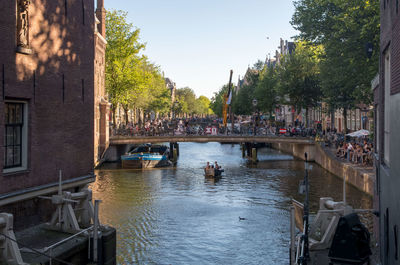 Boats in canal along buildings