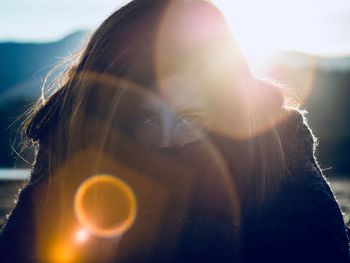 Close-up portrait of young woman on sunny day