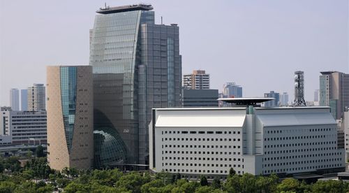 Modern buildings in city against clear sky