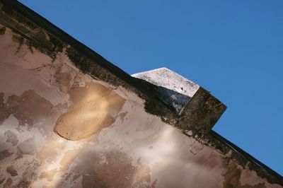 Low angle view of built structure against clear blue sky