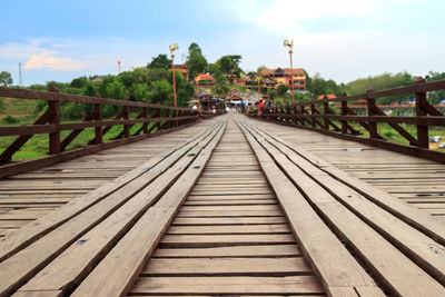 Footbridge over sea against sky