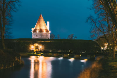 Low angle view of illuminated building against sky at night