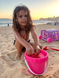 Portrait of happy girl on beach during sunset