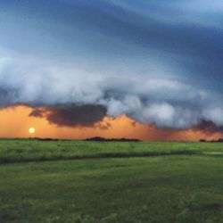 Scenic view of field against sky during sunset