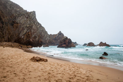 Scenic view of beach against clear sky