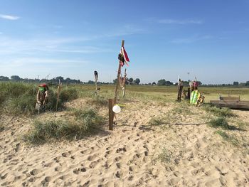 Wooden poles at beach against sky