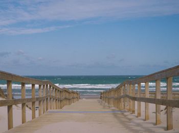 Pier over sea against sky