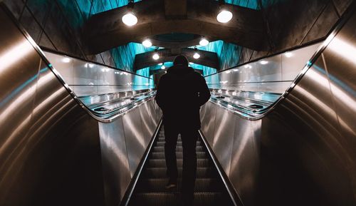 Low angle view of man standing on escalator