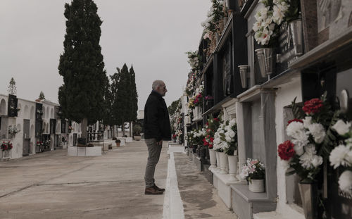 Adult man mourning his family in cemetery. almeria, spain