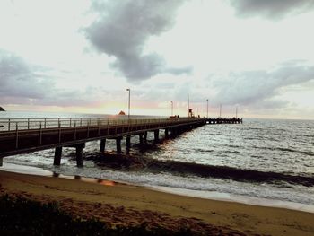 Pier over sea against sky