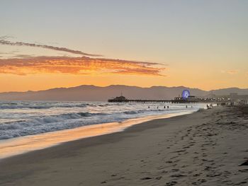 Scenic view of beach against sky during sunset