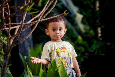 Portrait of cute boy standing outdoors