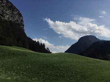 Scenic view of green landscape against sky