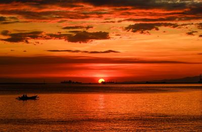 Scenic view of dramatic sky over sea during sunset