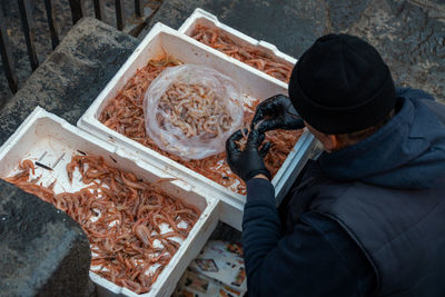 High angle view of man working on barbecue grill