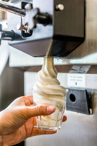 Close-up of hand holding ice cream