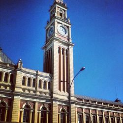 Low angle view of clock tower against clear sky