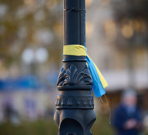 Blue and yellow silk ribbon tied on a metal tube. ukrainian flag symbol, struggle for independence.