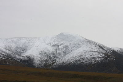 Scenic view of snowcapped mountains against clear sky