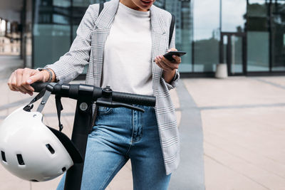 Midsection of man using mobile phone