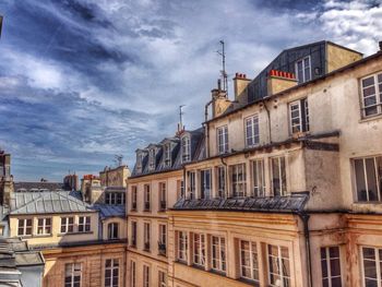 Buildings against cloudy sky