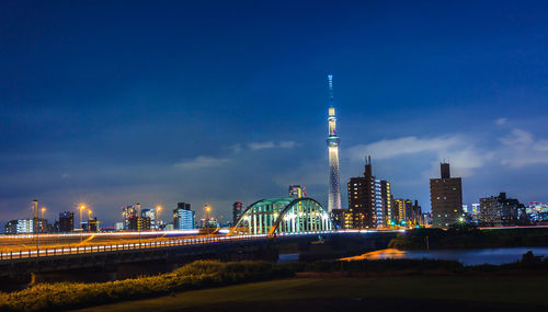 Illuminated buildings against sky at night