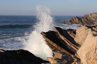 Waves splashing on rocks at shore