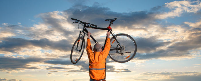 Low angle view of bicycle against sky during sunset