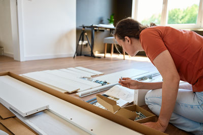 Side view of woman working at home
