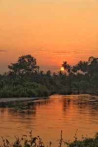 Scenic view of lake against orange sky