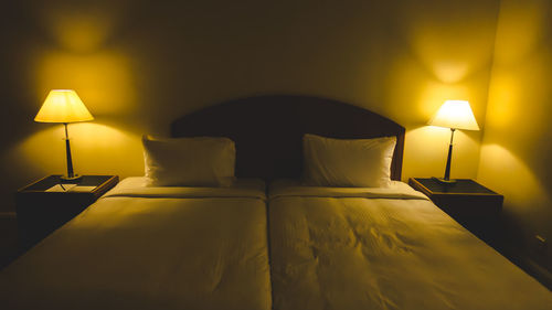 Illuminated electric lamp on bed