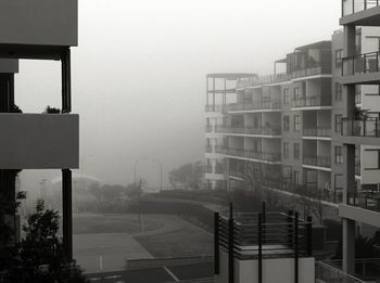 View of buildings in foggy weather