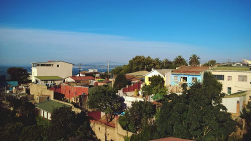 Houses in town against clear blue sky