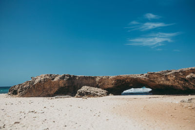 Scenic view of beach against blue sky