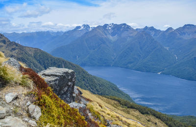 Scenic view of sea and mountains against sky