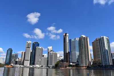 Low angle view of skyscrapers against cloudy sky