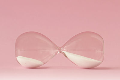 Close-up of pink glass against white background