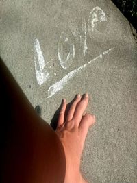 Close-up of human hand on sand