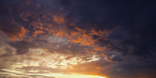 Low angle view of dramatic sky during sunset