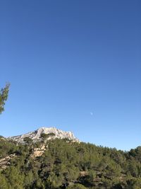 Scenic view of mountains against clear blue sky